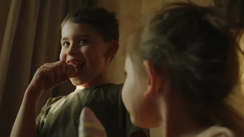Children snacking at home, creating warm family bonding moments filled with joy Stock Footage 277039778