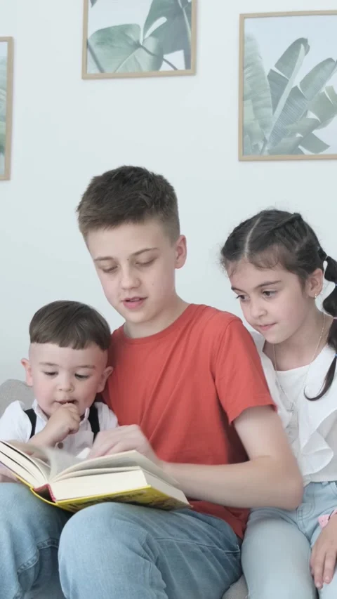 Children spend time together reading, developing their imagination and Video stock 312843155
