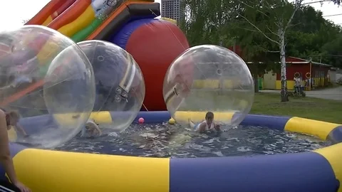 Children in spheres on water Stock Footage 71298751