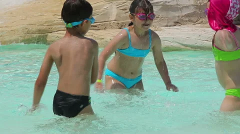 Children splash water in the pool Stock Footage 57908233