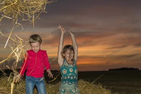 Children on a stack of straw Stock-Fotos