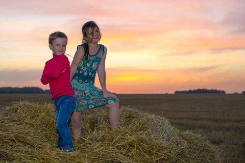 Children on a stack of straw Foto stock