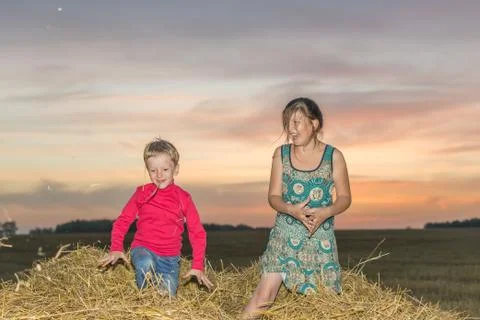 Children on a stack of straw Foto stock