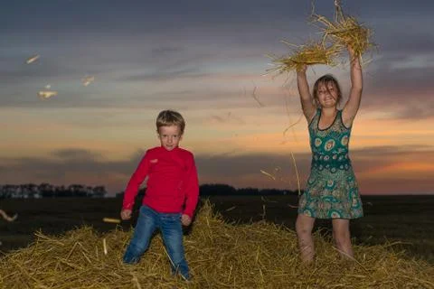 Children on a stack of straw Foto stock