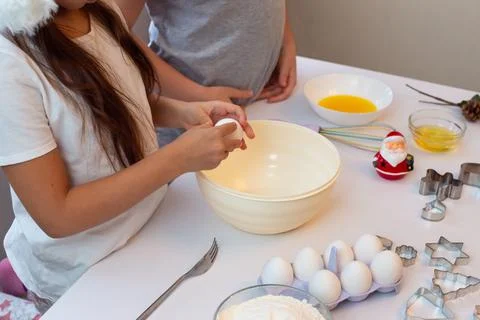 Children stand at a white kitchen table, prepare Christmas cookies in the Stock Photos