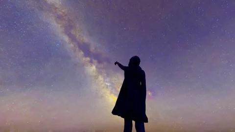Children standing on the top of the mountain looking up at the stars and exp Stock Footage 291000586