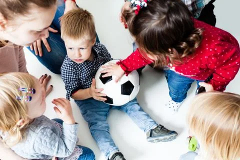 Children stretch to the ball Stock Photos