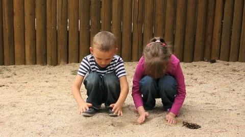 Children strew sand through hands Stock Footage 11483413