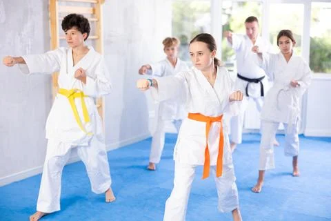 Children students repeat position and perform sequence of punches and painful Stock Photos