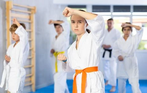 Children students repeat position and perform sequence of punches and painful Stock Photos