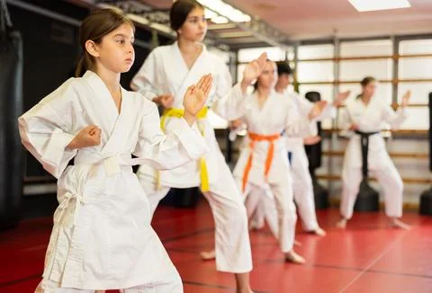 Children students repeat position and perform sequence of punches and painful Stock Photos