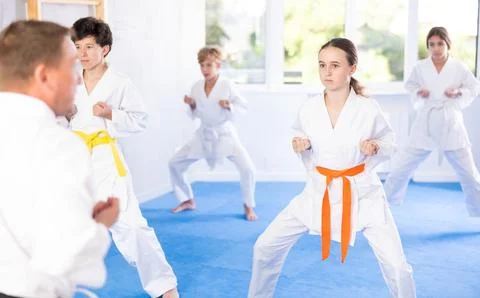 Children students repeat position and perform sequence of punches and painful Stock Photos