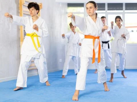 Children students repeat position and perform sequence of punches and painful Stock Photos