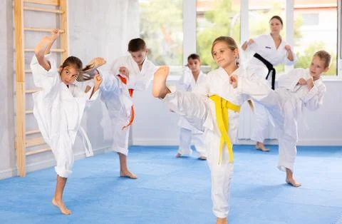 Children students repeat position and perform sequence of punches and painful Stock Photos