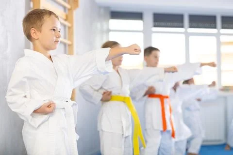 Children students repeat position and perform sequence of punches and painful Stock Photos