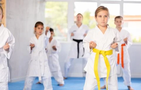 Children students repeat position and perform sequence of punches and painful Stock Photos