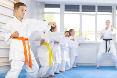 Children students repeat position and perform sequence of punches and painful Stock Photos