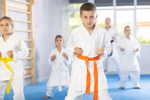 Children students repeat position and perform sequence of punches and painful Stock Photos