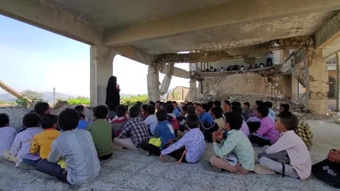 Children study inside a school destroyed by the war Stock Footage 160577163