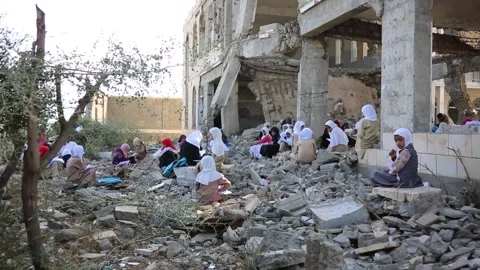 Children study inside a school destroyed by war in Yemen, Taiz Stock Footage 197048786