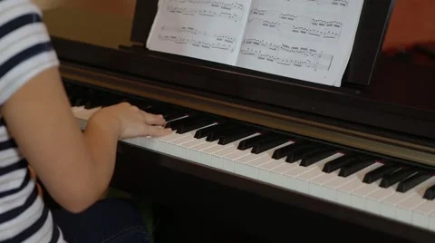 Children study at piano Stock Footage 55751971