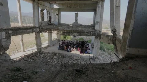 Children studying in a school destroyed by the war in Yemen Stock Footage 160574358