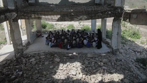 Children studying in a school destroyed by the war in Yemen Stock Footage 160574506