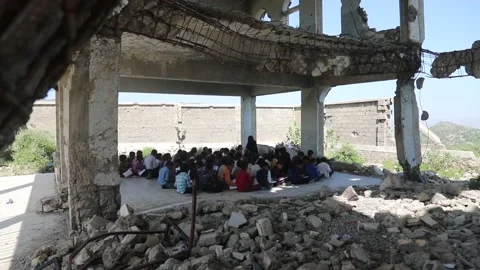 Children studying in a school destroyed by the war Stock Footage 160576412