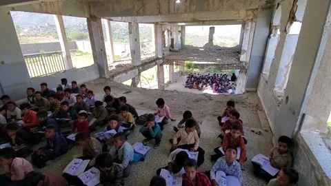 Children studying in a school destroyed by the war in Yemen Stock Footage 160576926