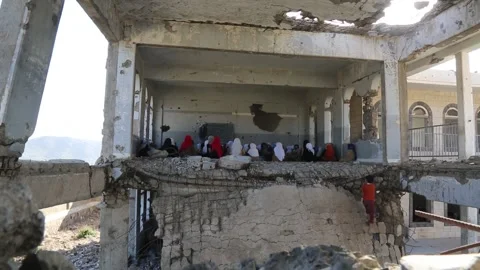 Children studying in a school destroyed by the war in Yemen Stock Footage 235617555
