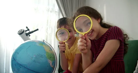 Children is studying while sitting at home in rays sun in room.Kid in morning Stock Footage 273640711