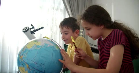 Children is studying while sitting at home in rays sun in room.Kid in morning Stock Footage 296260222