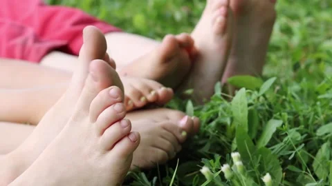 Children sunbathe in the park, walking bare foot Stock Footage 158494003