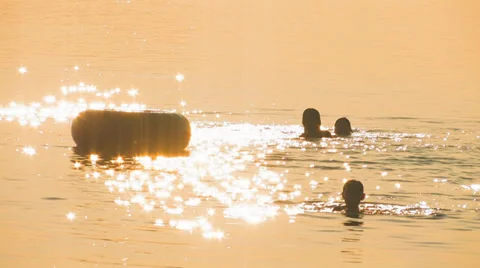 Children swimming on sunset Stock Footage 35152877