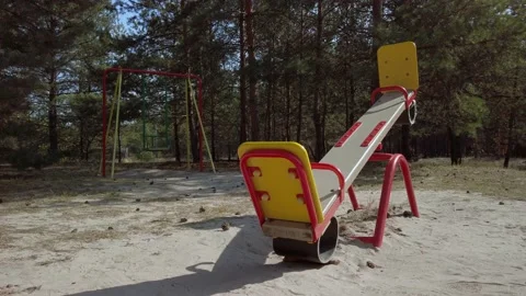 Children swing moves in the wind in a pine forest. Stock-Footage 140013633