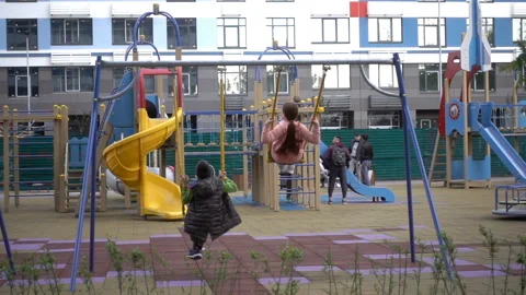 Children swing on a swing in slow motion Stock Footage 140471397