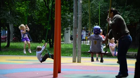 Children swinging on a swing Stock Footage 52559273