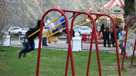 Children swinging on a swing Stock Footage 67363167