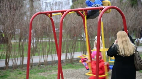 Children swinging on a swing Stock Footage 67363168