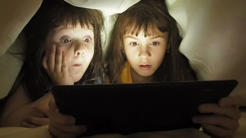 Children with a tablet under the blanket. Stock Footage