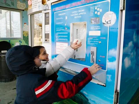 Children take raw milk from a distributor Stock Photos
