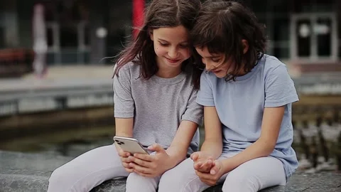Children taking selfie on smartphone Stock Footage 166154972