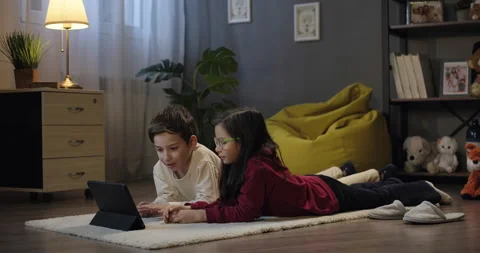 Children talk to webcam on digital tablet in the evening, video chat conference Stock Footage 275913647