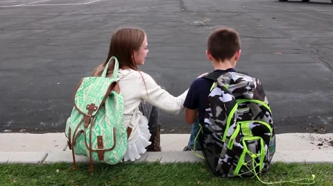 Children talking sitting on a curb HD  Stock-Footage 68435800
