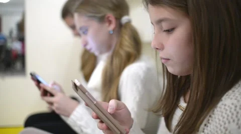 Children with their Smartphones and mobile phone in school Stock Footage