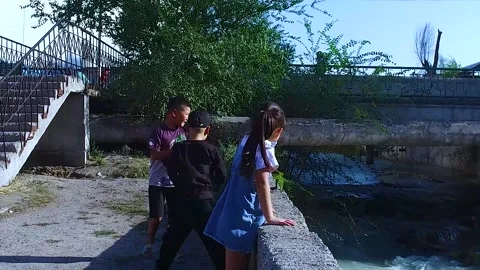 Children throw garbage into the river. Stock Footage 251953430