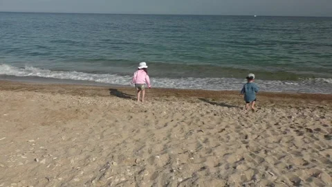 Children throw pebbles into the water. Stock Footage 163843810