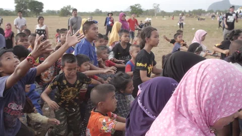 Children trying to catch candy running and pushing each other falling down Stock Footage 163881617