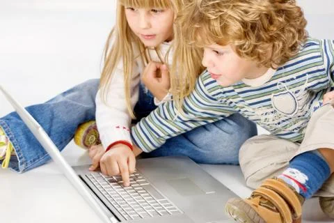 Children turning on computer Stock Photos