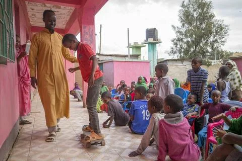 Children at a tutorial school learning to skate on a donated skateboard we... Stock Photos